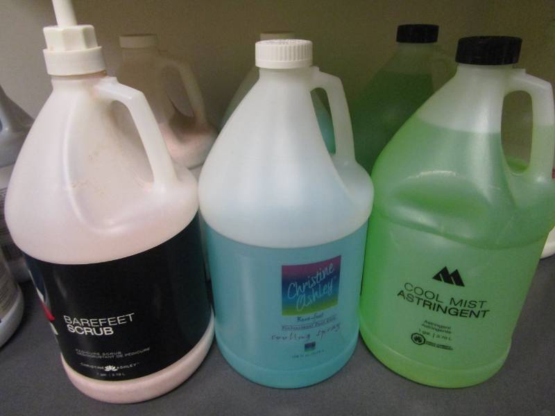 lot 1115 image: Astringent, Cooling Spray and Scrub Gallon Jugs Lot