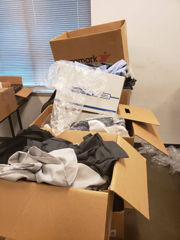 lot 9191 image: Large lot of clothing on table