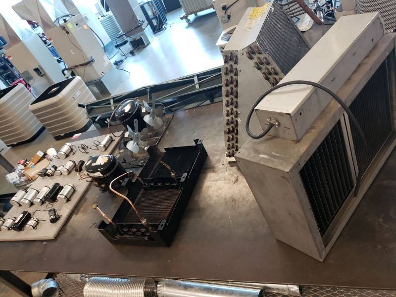 lot 8051 image: Air conditioner parts on table
