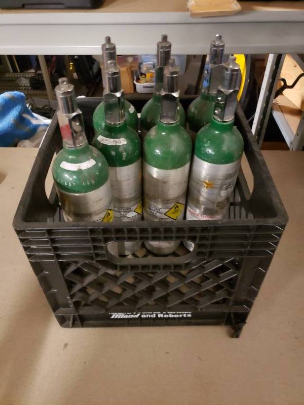 lot 10821 image: Crate of 7 Smaller Oxygen Bottles