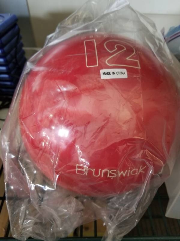 lot 3177 image: Brunswick 12lb Red Cosmic Bowling Ball Not Drilled