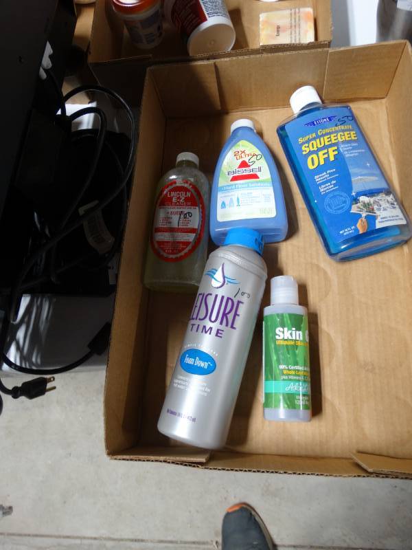 lot 6130 image: Lot with small hard floor bissel solution, skin gel, lincoln ez cleaner, simple spa care foam down and squeegee off glass cleaner.