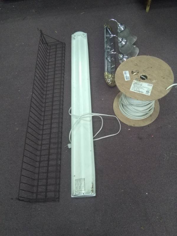 lot 2392 image: Metal Peg Board Shelf, Florescent Plug In Fixture, Bath Fixture, Spool of Wire