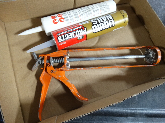lot 6363 image: Caulking gun and caulk.