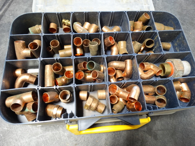 lot 6422 image: Tool bin with copper fittings.