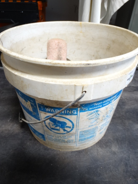 lot 6502 image: Bucket with a strap, work belt, paint roller cover and more.