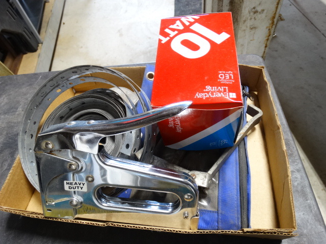 lot 6512 image: Lot with staple gun, light bulb, tape measure, plumbers tape and more.