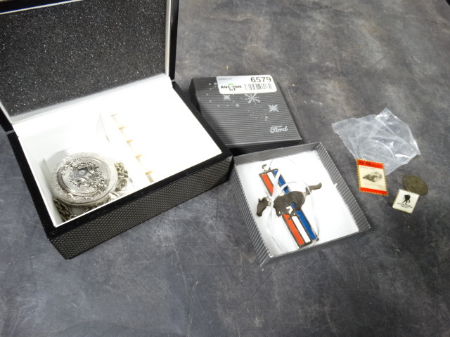 lot 6579 image: James Michael pocket watch, mustang ornament, nra coin and more.