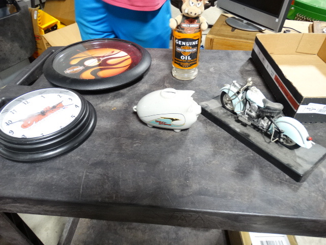 lot 6593 image: Lot with harley davidson clock, indian motorcycles clock, harley davidson piggy bank and more.