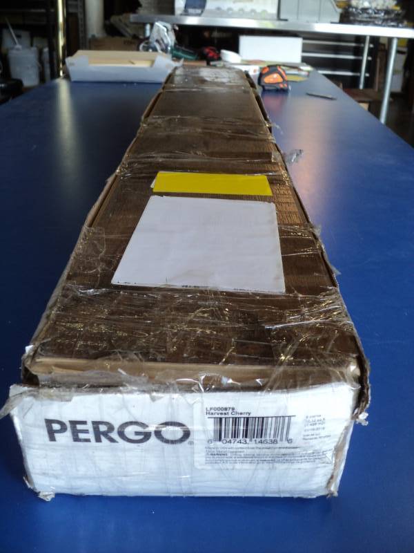 lot 7207 image: (1) box Pergo Laminate Flooring, 8 planks, 16.2 sq. ft. Harvest Cherry LF000879