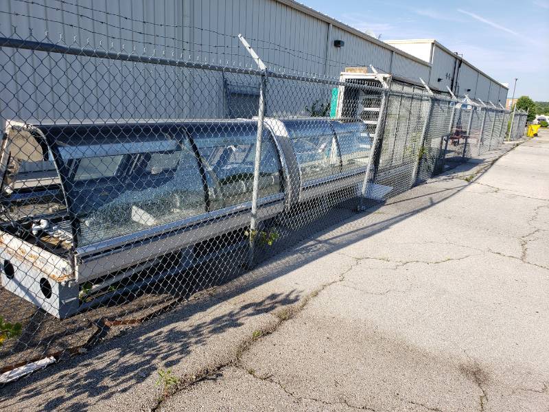 lot 8804 image: Lot (4) scrapparts display cases behind building