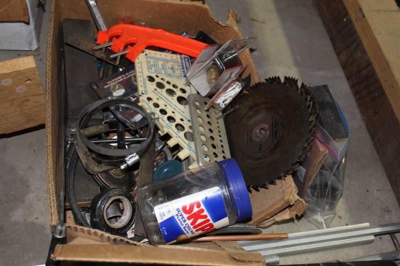lot 1268 image: 4 Boxes of Misc. Metal Parts, Brackets, Door Handle with Lock and Key, Very Heavy Small Safe (not opened), Saw Blades, Sanding Pads, Small Shelf on Casters, Other Various Garage Finds