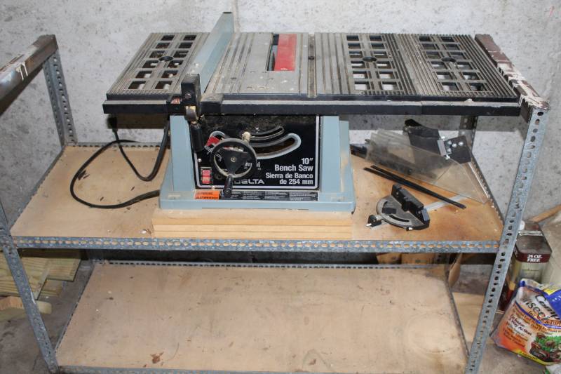 lot 1276 image: Delta 10 in. Bench Saw  with shelving unit