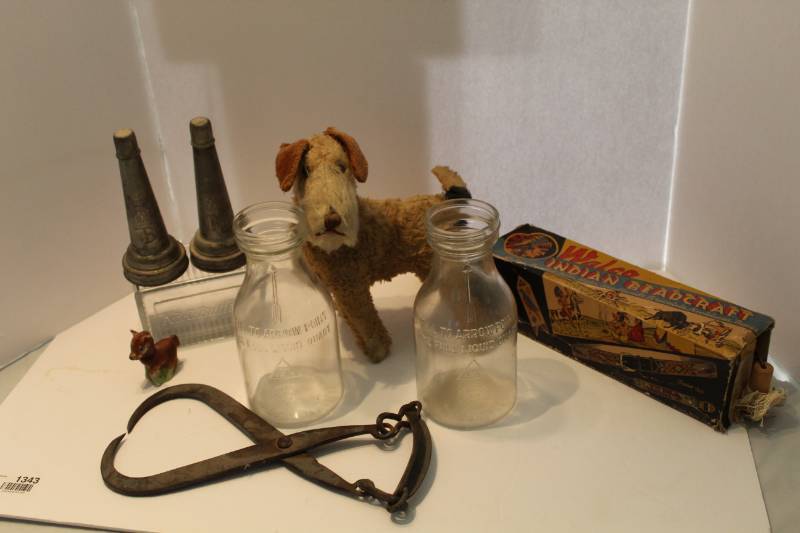lot 1343 image: Antique Toys, iron ice clawgrabber, glass bottles, tin oil spouts, Glass item that says ABC Butter