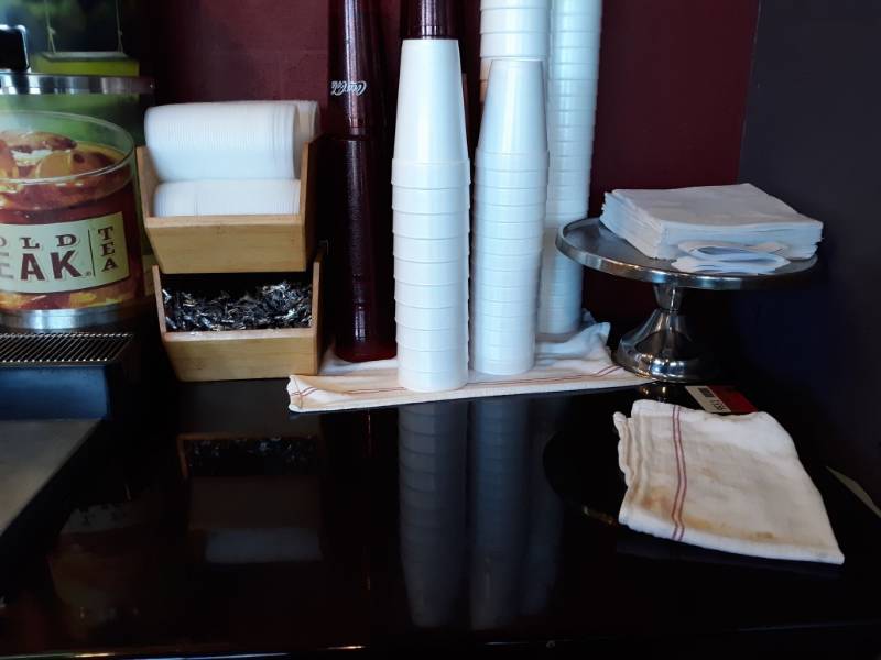 lot 1556 image: Table - Single Stand, wood counter organizer, Red Coca Cola cups, metal cake stand,