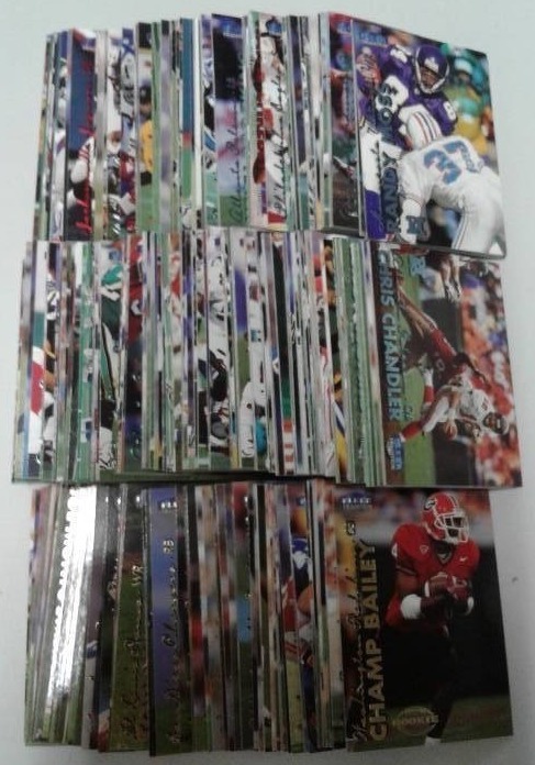 lot 1121 image: 1999 Fleer Tradition Football Trading Card Complete Set - 300 Total Football Cards With McNabb, Edge James, Champ Bailey Rookies