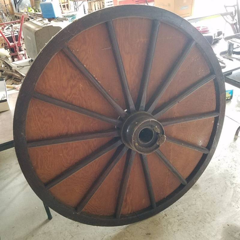 lot 7244 image: wooden wagon wheel with plywood attached