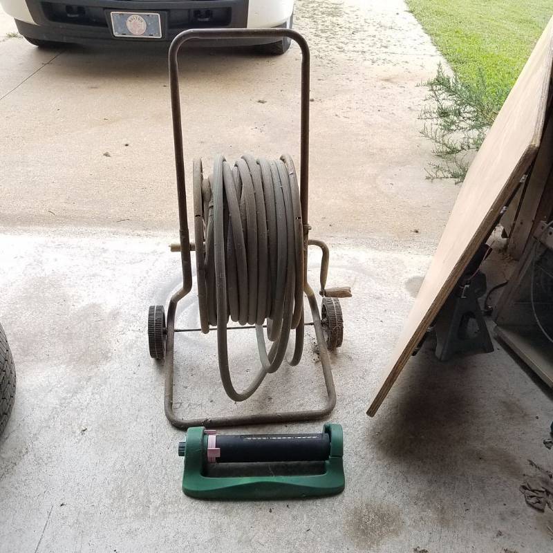 lot 7256 image: garden hose on reel, sprinkler, additional garden hose