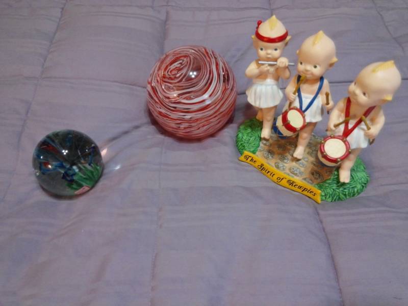 lot 7918 image: Glass Paper weight Balls and Kewpie Figurine