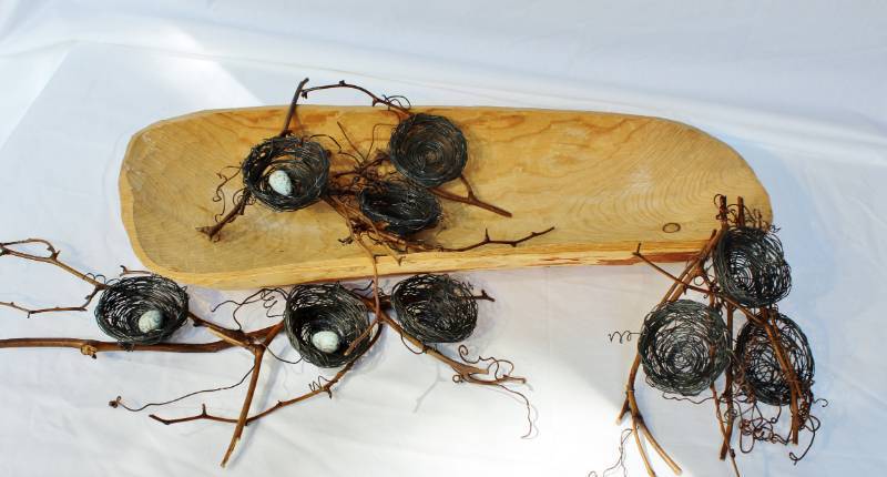 lot 1581 image: Hand carved Wood Log into a vessel single piece of wood.  Wire birds nests with twigs