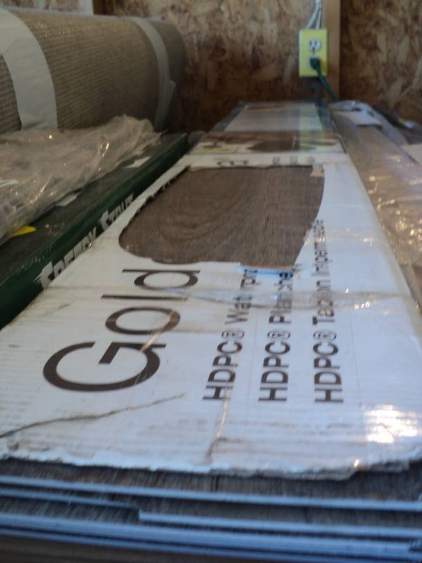 lot 9375 image: (1) box Golden Arawana Rigid Core Vinyl plank flooring, 7 planks, 7-14 x 48, Sandalwood Color