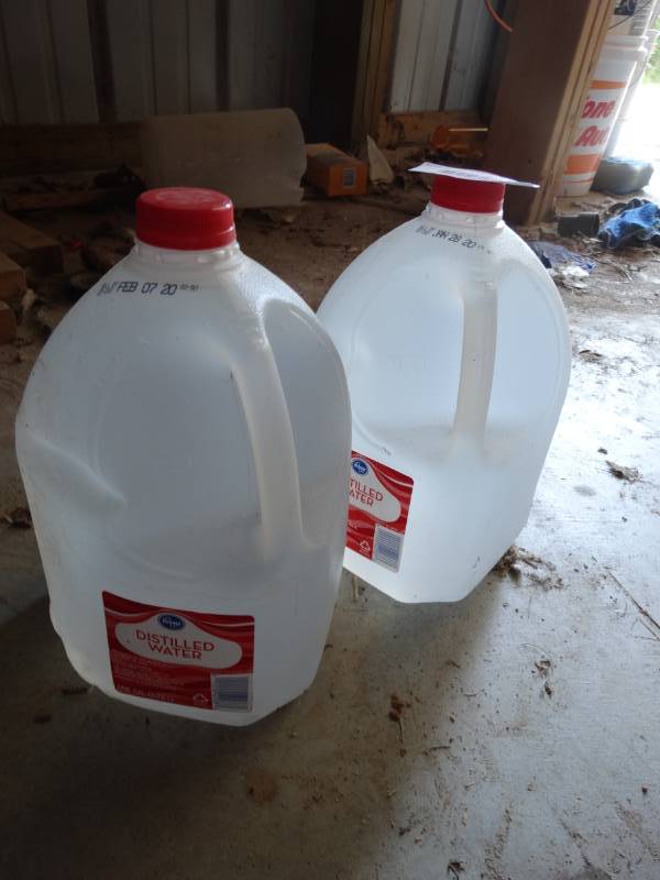 lot 1044 image: 2 gallons of distilled water