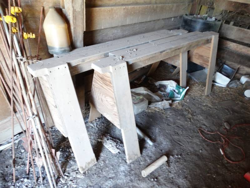 lot 2049 image: Contents of room in barn- electric fence posts saw horses misc.