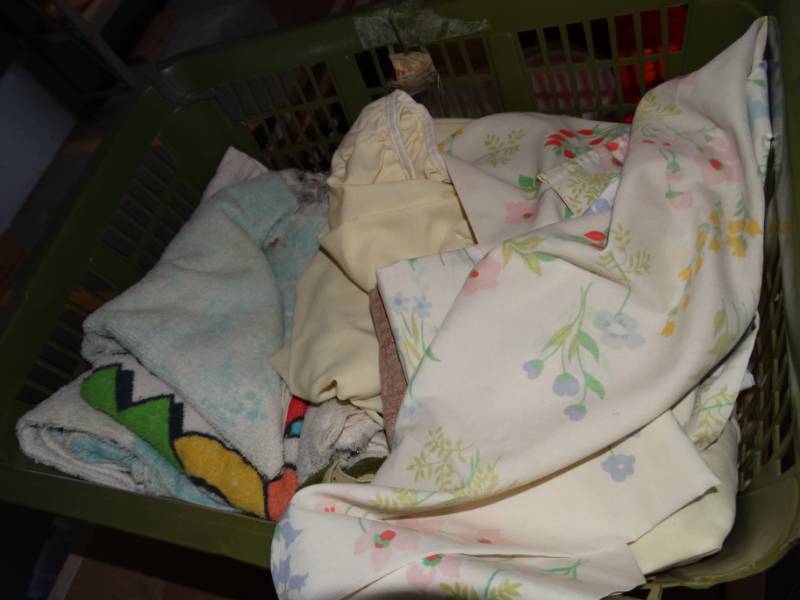lot 490 image: Laundry basket with towels and sheets.