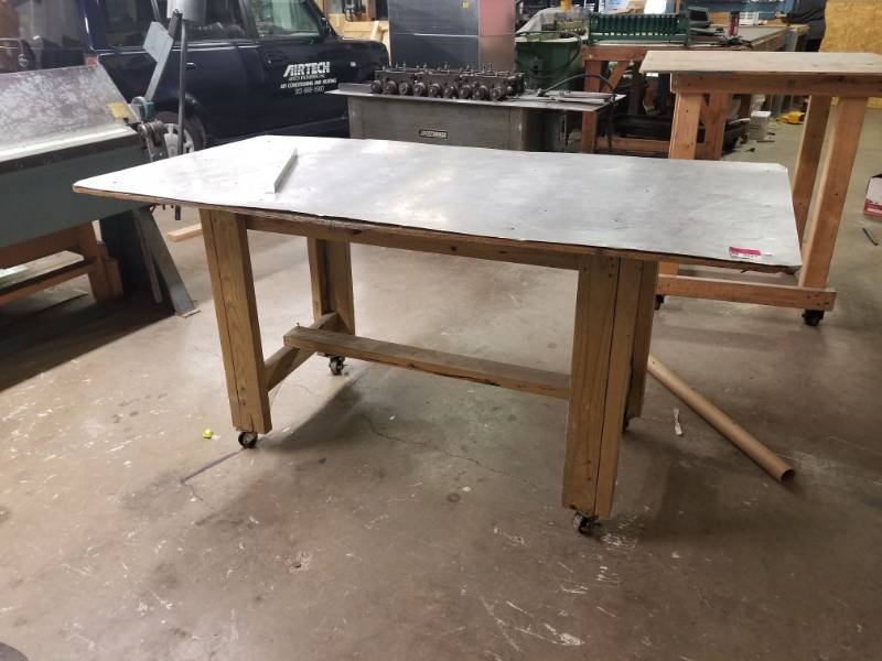 lot 2681 image: Wood Work Table With Metal Top On Wheels