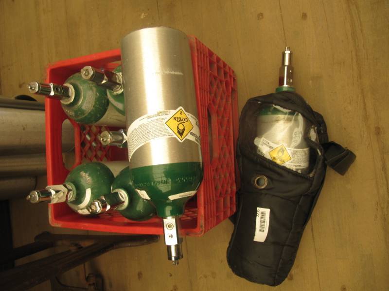 lot 2235 image: 7 portable oxygen tanks and one portable carrying case