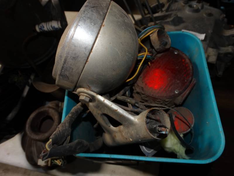 lot 135 image: Motor bike headlight and parts.