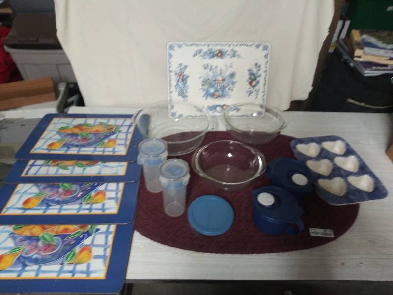 lot 2076 image: Pyrex serving bowls, Hard back placemats with blue boarder, large hot mat, Ceramic heart shaped cupcake pan, storage containers with lids.