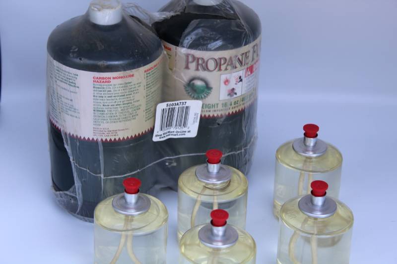 lot 1864 image: (2) sm Propane Tanks (new) and 50hr Wax Oil Wick Burners