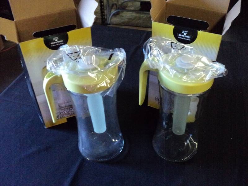 lot 9875 image: (2) Ergo Glass pitcher with plastic cooling tube center