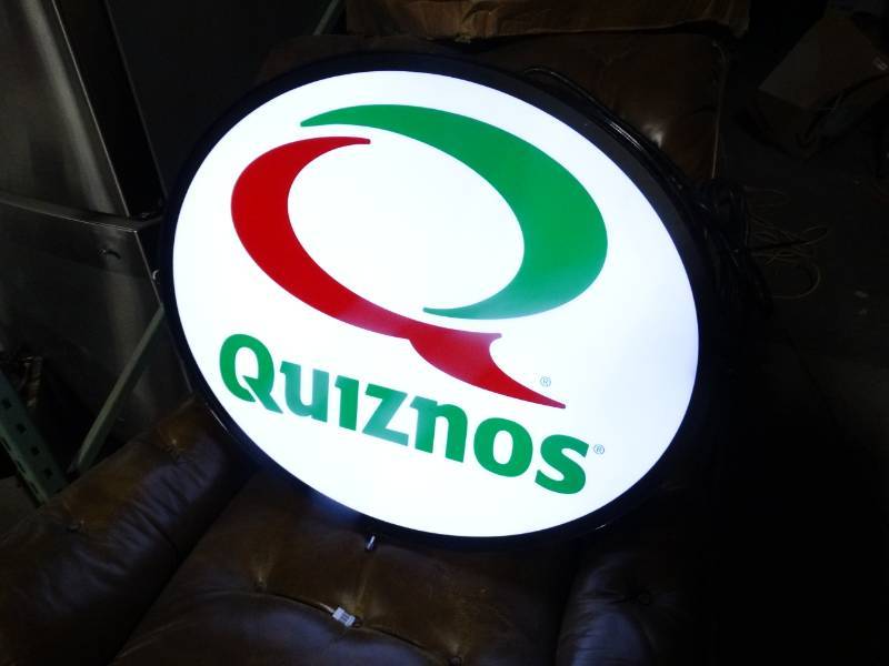 lot 1547 image: Double sided lighted oval sign- Quiznos