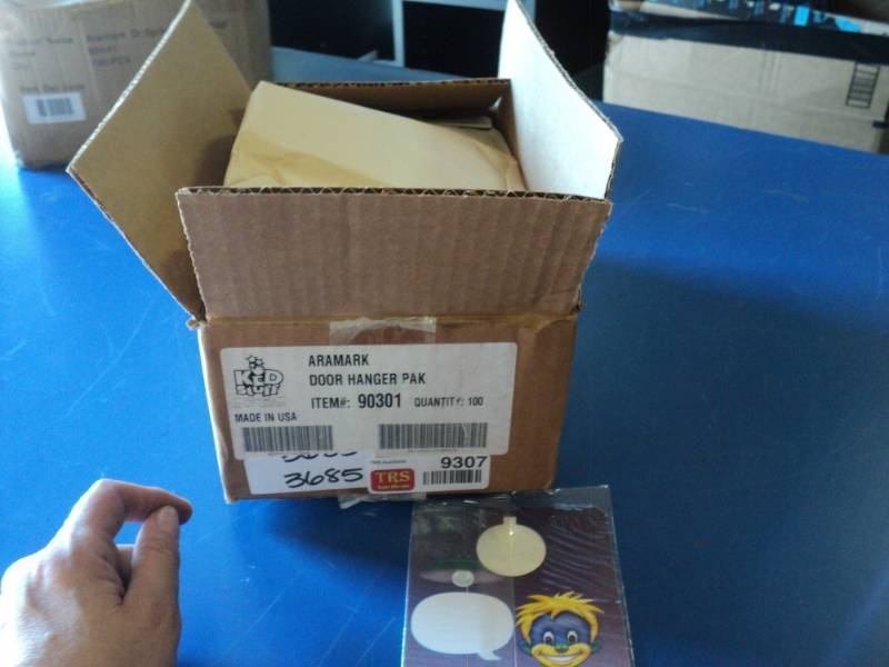 lot 9308 image: (1) box Aramark Kid Stuff Door Hanger pack, (100)