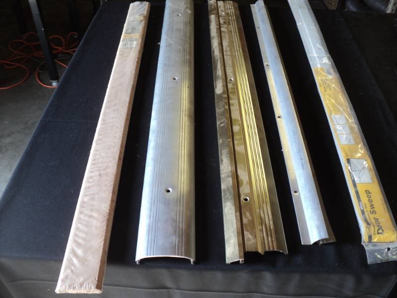 lot 9933 image: (5) ct mixed lot door sweeps and thresholds, assorted sizes and styles