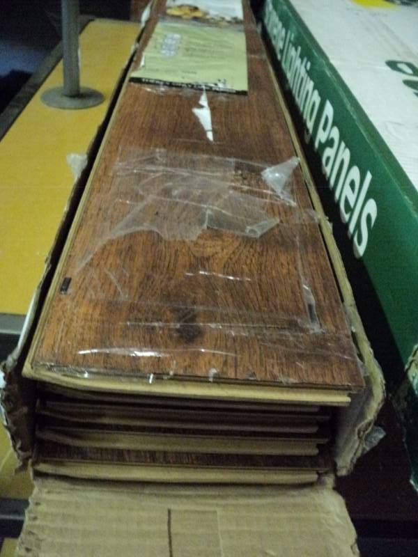 lot 10058 image: (1) box Pergo Laminate Flooring, (8) planks, 19.63 sq. ft., Hillcrest Hickory