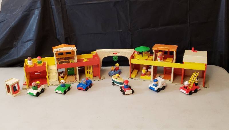lot 1313 image: Vintage Fisher Price Little People City Set with numerous Little People and their Vehicles