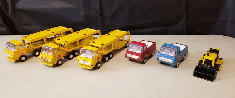 lot 1315 image: Lot of (6) Pieces of Vintage Mini Tonka Vehicles - 3 Car Haulers, 2 Trucks, and 1 Front End Loader (no tracks)