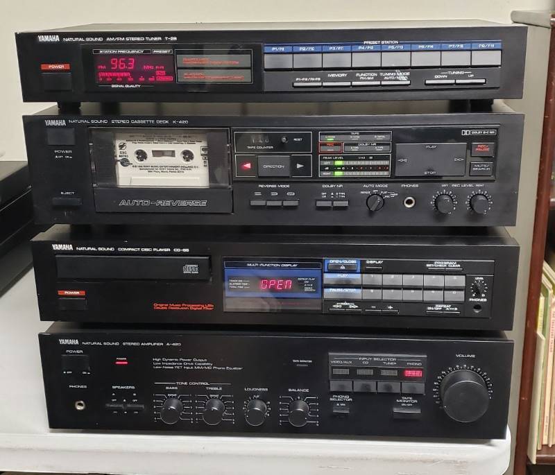 lot 1363 image: 4 components of Yamaha Natural Sound Stereo System - Stereo Amplifier A-420, Compact Disc Player CD-55, Stereo Cassette Deck K-420, and AMFM Stereo Tuner T-28 (WORKS - CD player has some issues)