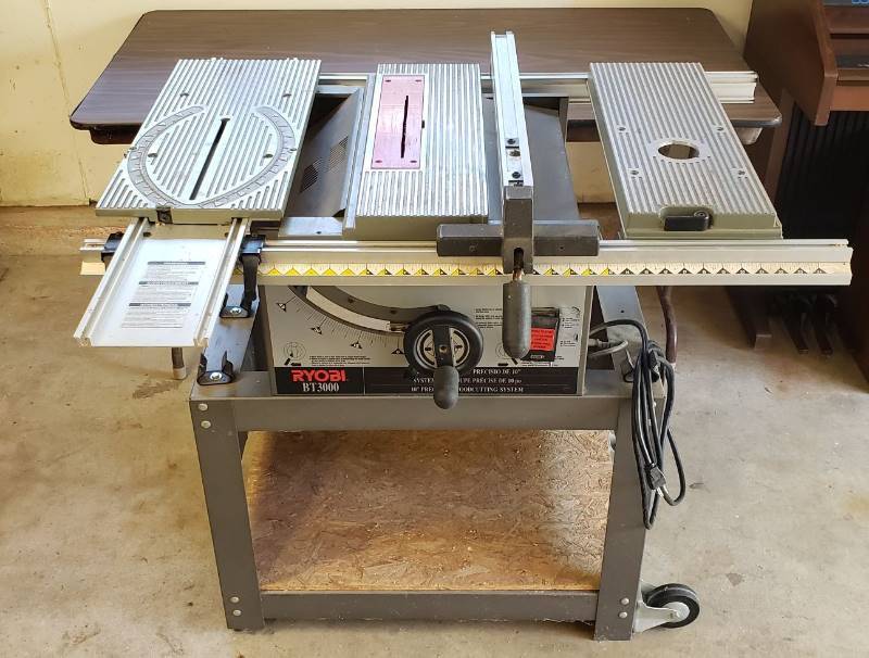 lot 1366 image: Ryobi BT3000 10  Table Saw on Stand with 2 adjustable platforms and moveable rail - WORKS