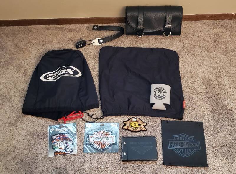lot 1527 image: Harley Davidson Patch Emblems, Leather Book, (2) Helmet Covers and Leather Bike Bag
