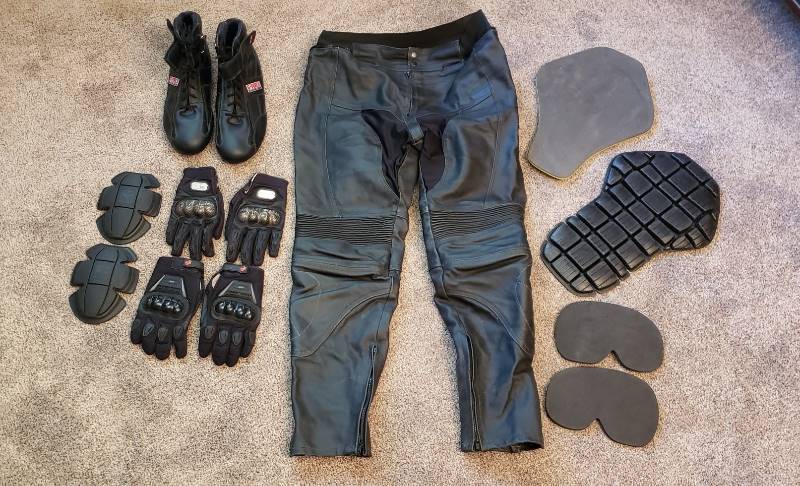 lot 1535 image: Lot of Biking Leather Pants (Euro Size 46), Boots (Size US 14), 2 Pair Large Size Gloves, and Assorted Armor Gear
