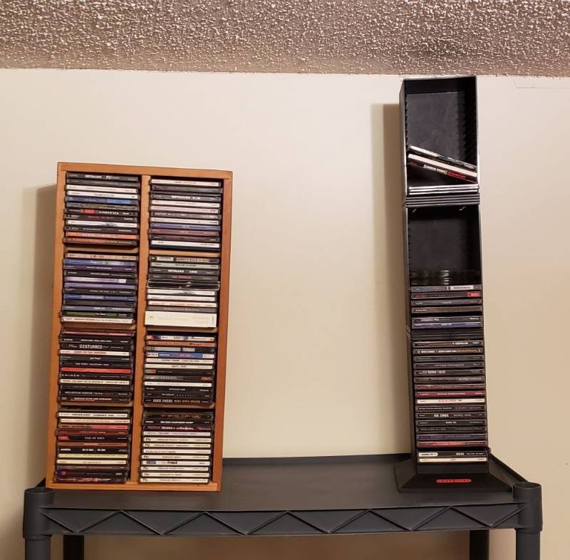 lot 1724 image: 2 CD Storage Racks with CDs - Wooden CDs are into Matching Cases and the Plastic One - some Loose CDs and Empty Cases