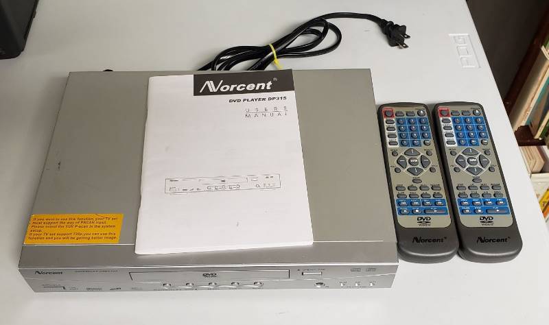 lot 1728 image: Norcent DVD player DP315 - powers on with Remotes