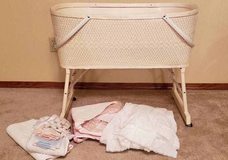 lot 3203 image: Vintage Honeysuckle Bassinette with Mattress, Coverings, and Sheets - 31  x 19  x 27  - folds up legs - box included
