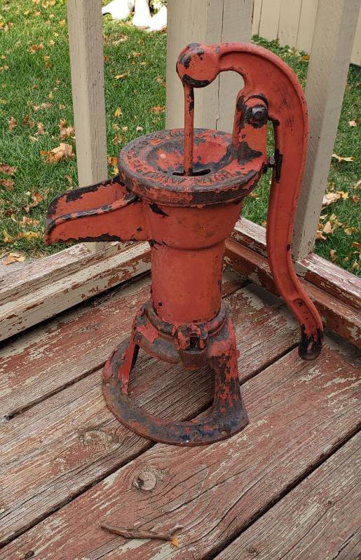 lot 2245 image: Nelson Bros. Co. Red Pitcher Pump - 18 in. tall