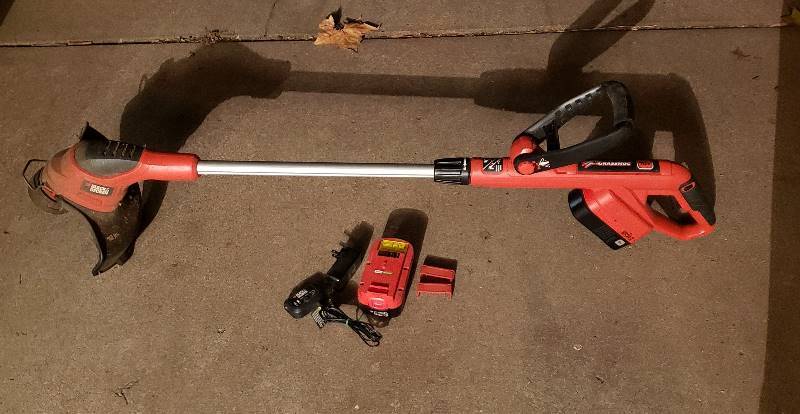 lot 2265 image: Black and Decker GrassHog 18V Battery Powered Trimmer with charger and extra battery
