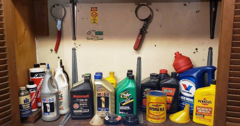 lot 2332 image: Lot of Automotive Fluids - Oils, TransmissionFluid, Gear Lube, Brake Fluid, and Oil Charging Tools - most containers are full
